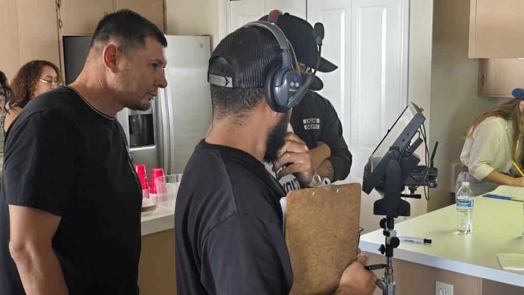 Director Gonzalo Alatorre (left) reviews a scene on set with his production team, bringing The Chicano Story to life through focus, collaboration, and creative vision.